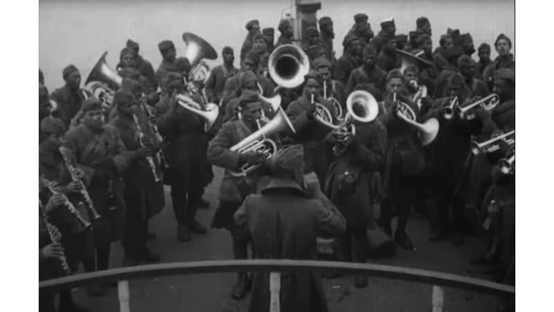 James Reese Europe conducting his band while troops disembark in New York City at the end of the war. Port of Disembarkation, New York Harbor [1919], Reel 2. Courtesy of the National Archives.