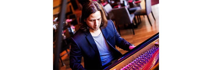 image of robert rodriguez rospide sitting at the piano