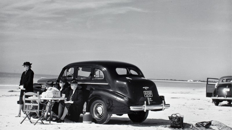 Image of women having picnic on beach