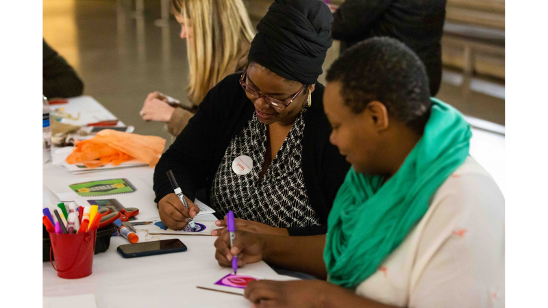 Teachers around a table working on an art project