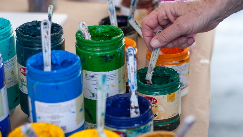 open paint jars with palette knives