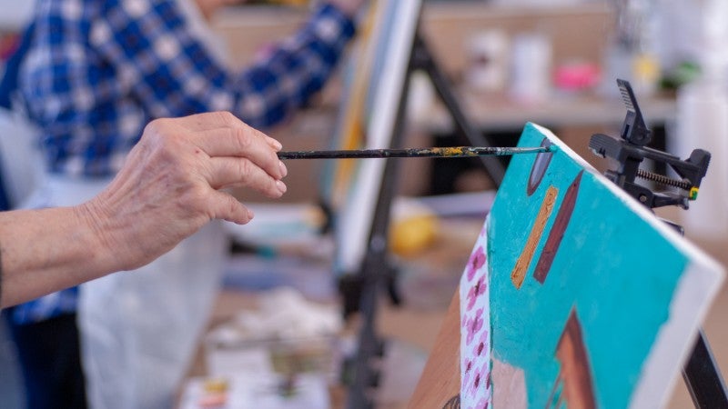 Student painting on canvas