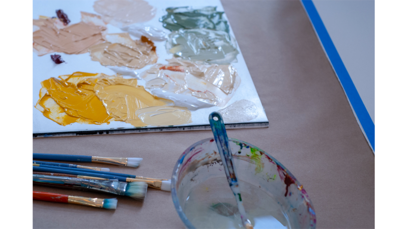 cardboard paint palette with brushes and water bowl