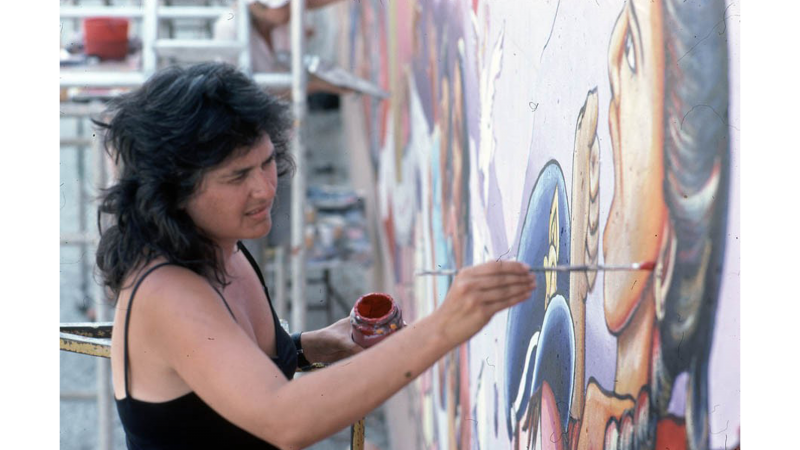Judy Baca painting The Great Wall of Los Angeles, summer of 1983, photo courtesy of the SPARC Archives (SPARCinLA.org)