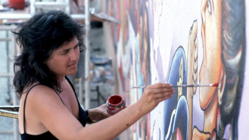 Judy Baca painting a mural 