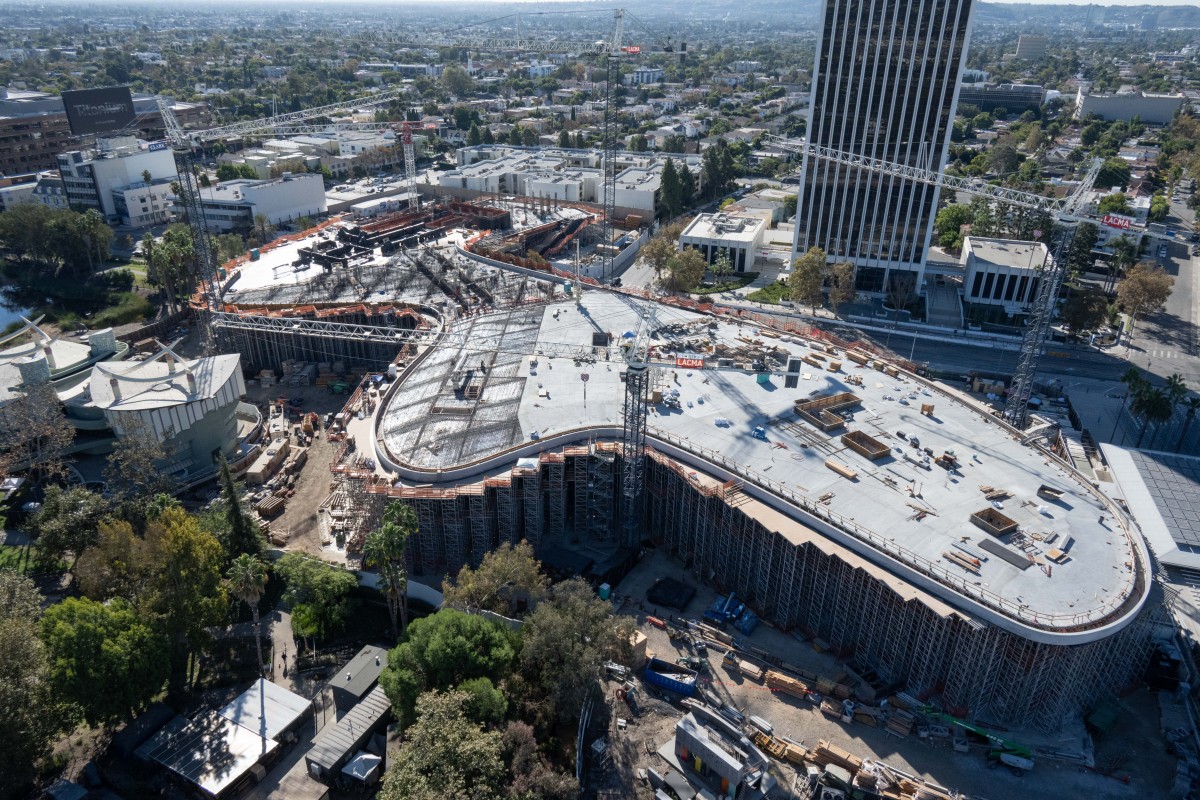Aerial view of gray organically shaped building under construction