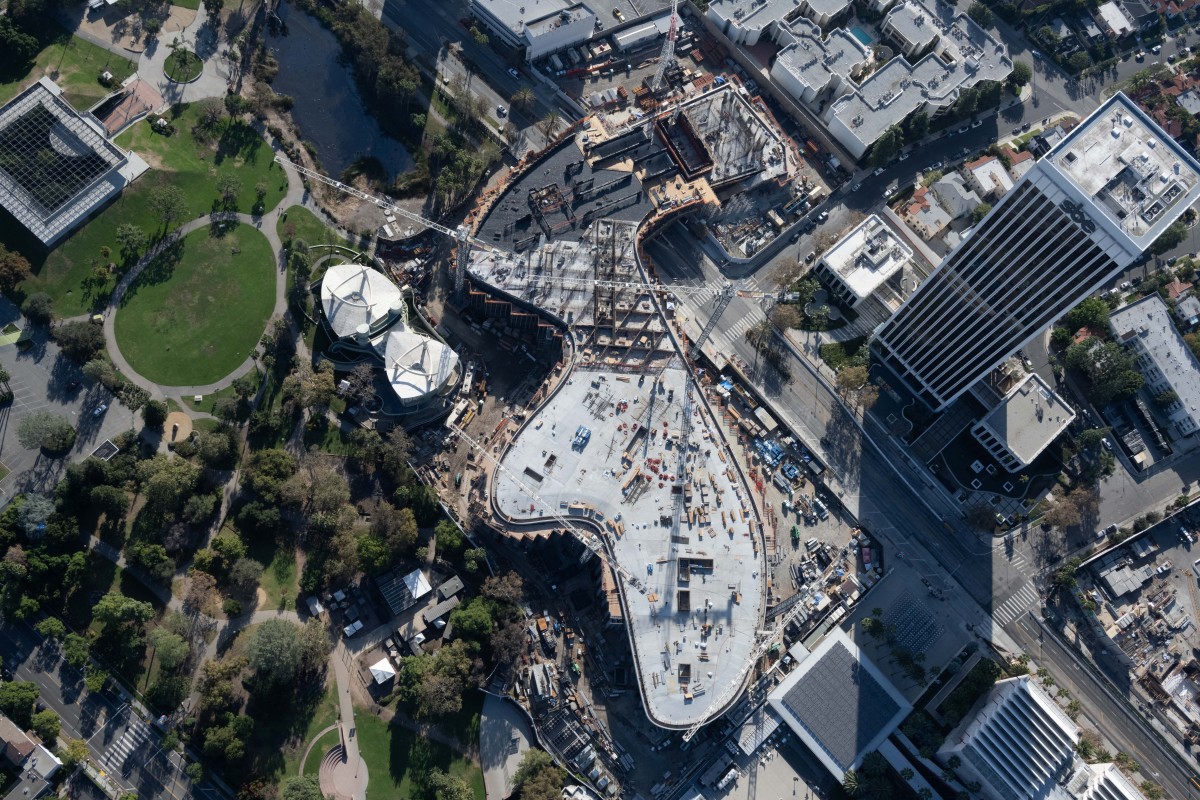 Aerial view of gray, organically shaped building under construction